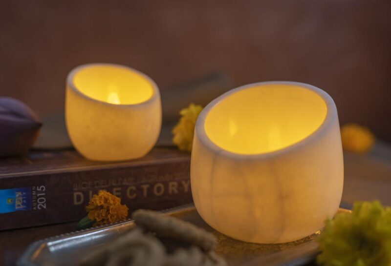 Rajasthani Twinkler candle holders in elegant white marble, casting a soothing light, nestled in a cozy home setting for a timeless appeal.