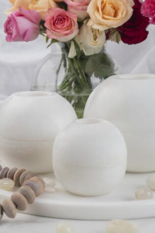 White marble Luminous floor candle holders set against a refined decor backdrop with roses, showcasing versatility and classic charm in home lighting.