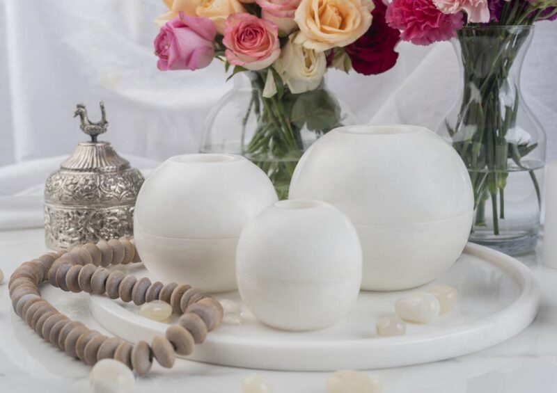 White marble Luminous floor candle holders set against a refined decor backdrop with roses, showcasing versatility and classic charm in home lighting.