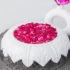 Natural Handicrafts' Fringe Candle Floater with leaf design, filled with pink rose petals and floating candles, offering a romantic and mystical charm.