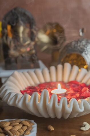 Handcrafted white marble bowl designed as a candle floater, set amidst festive decor, ideal for serene home ambiance.