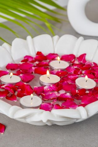 Natural Handicrafts' Calm Candle Floater with delicate flower design, adorned with vibrant rose petals and lit tea candles, creating a peaceful and romantic atmosphere.
