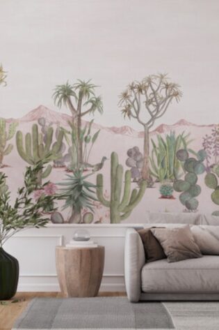 Panoramic view of the 'Desert Pink Sand' wallpaper in a modern living room, depicting a tranquil desert scene with cacti and distant mountains, enveloping the space in warmth and natural beauty.