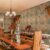 Opulent dining room adorned with Ramayan Jharokha Antique painting wallpaper, depicting scenes from the epic in a jharokha style, enhancing the room's cultural and aesthetic appeal.
