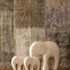 Marble elephant family artefacts by Natural Handicrafts on a textured surface